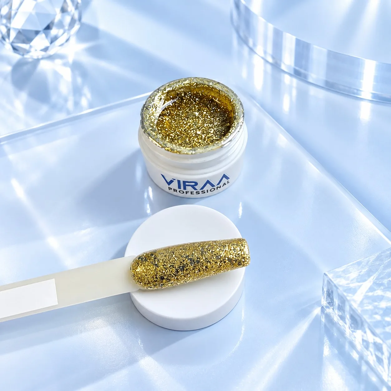 Viraa Pro High Density Platinum Gel shade 004, a champagne gold glitter, in its open 5gm pot with the shade painted on a sample tip