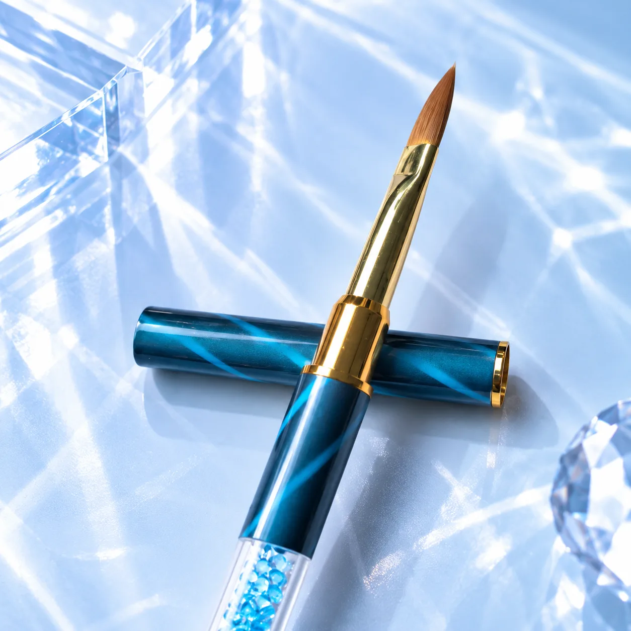 Angled brush from the VIRAA Professional 8pc nail art brush set, with a teal marbled barrel and a sky-blue crystal handle