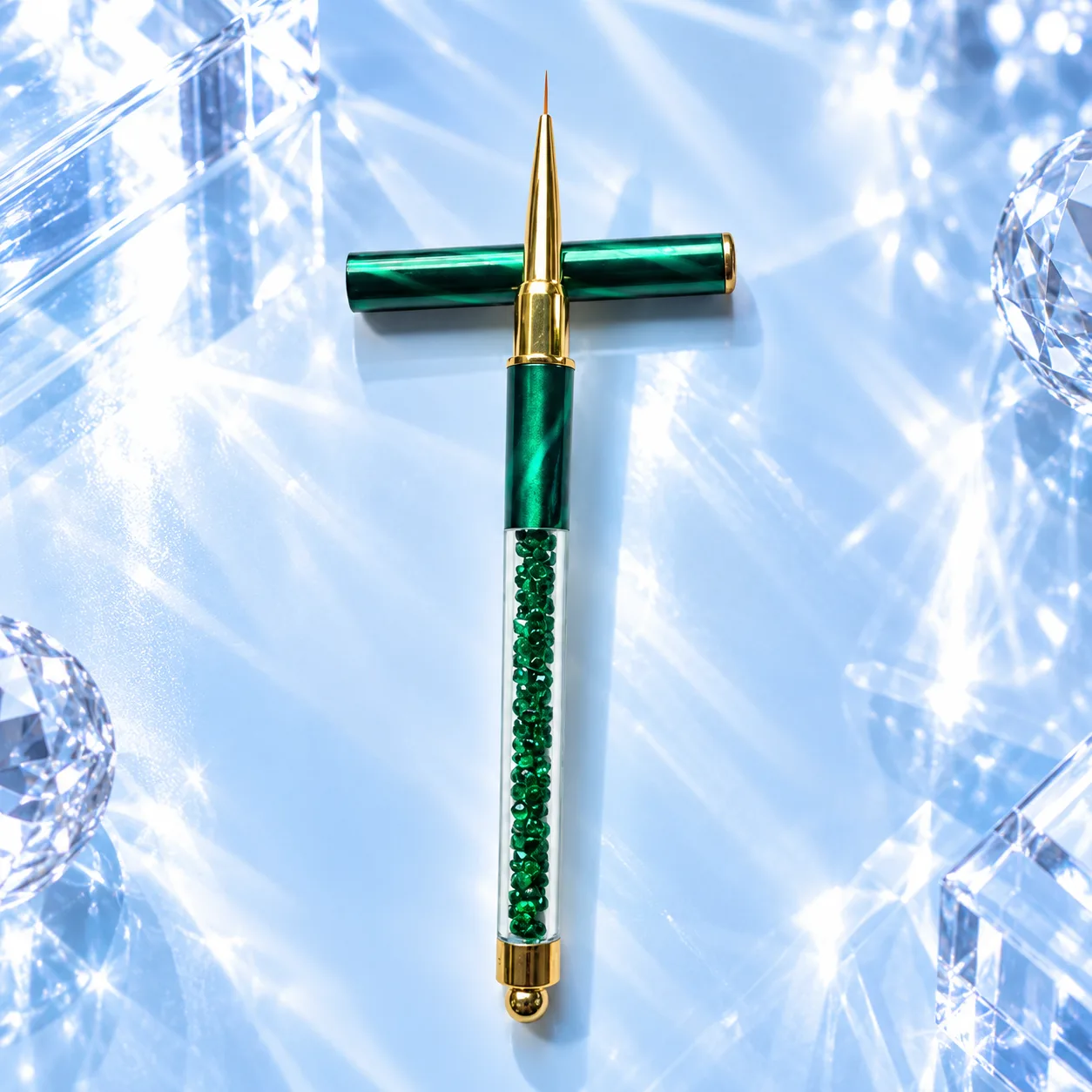 Fine liner brush from the VIRAA Professional 8pc nail art brush set, with a dark green marbled barrel and a green crystal handle