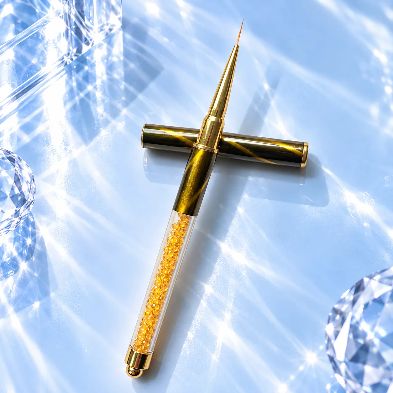 Fine liner brush from the VIRAA Professional 8pc nail art brush set, with a gold marbled barrel and an amber crystal handle