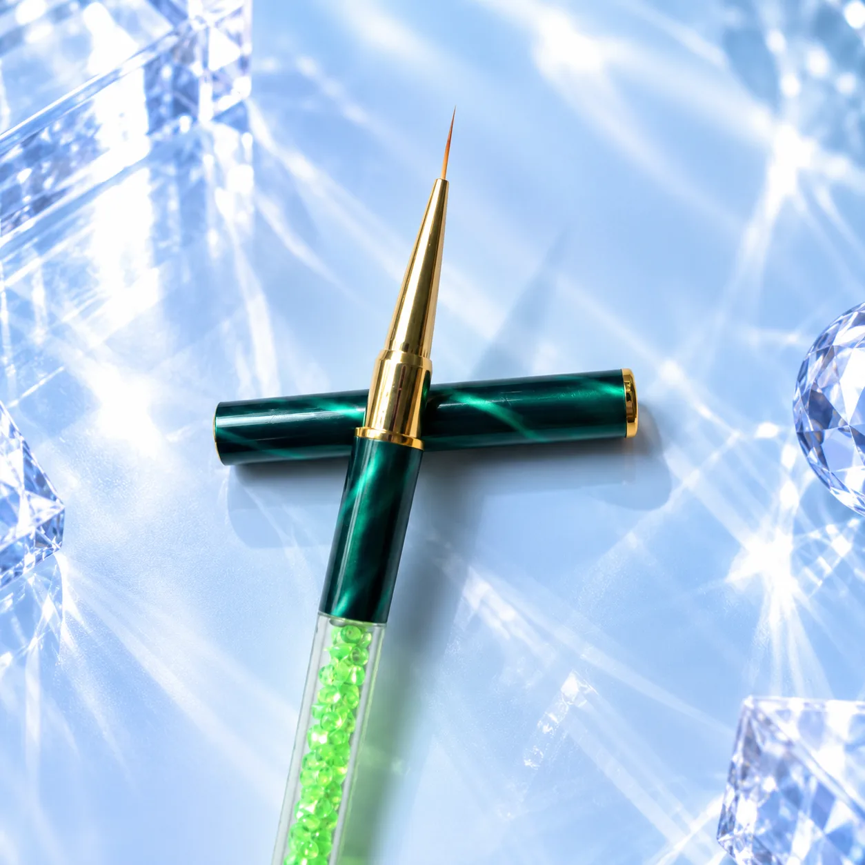 Fine liner brush from the VIRAA Professional 8pc nail art brush set, with a green marbled barrel and a lime-green crystal handle